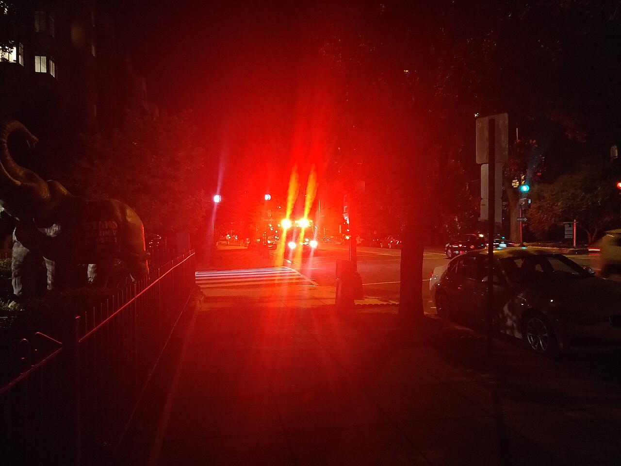 An ambulance with flashing lights on a dark street