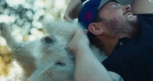 Mikael Lindnord hugs Arthur, the stray dog who followed his adventure racing team in Ecuador