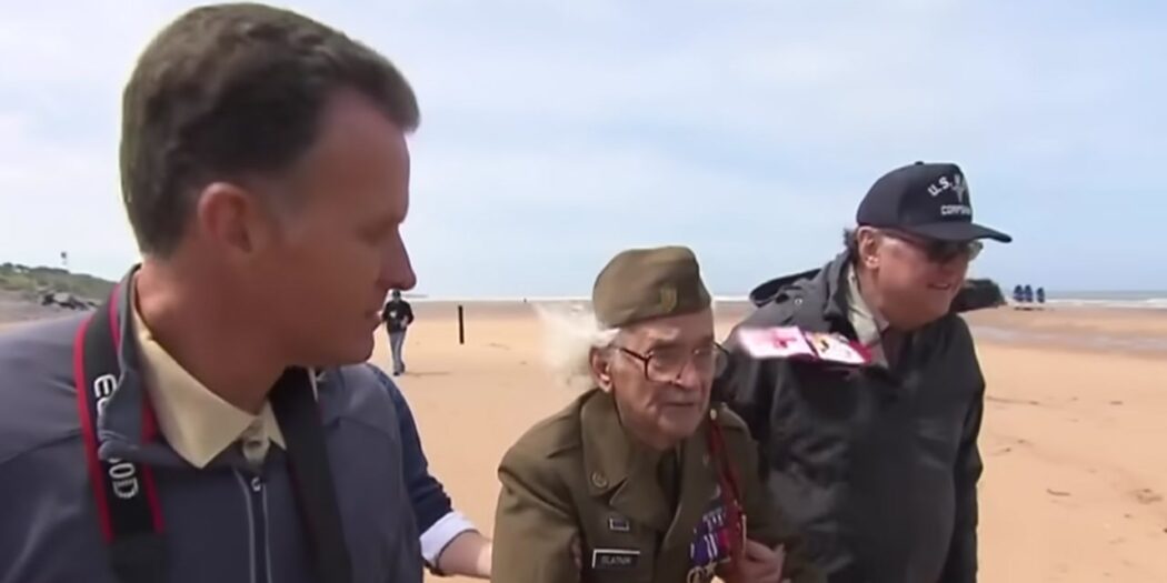 WWII veteran Robert Blatnik walking on Omaha Beach in Normandy in 2013