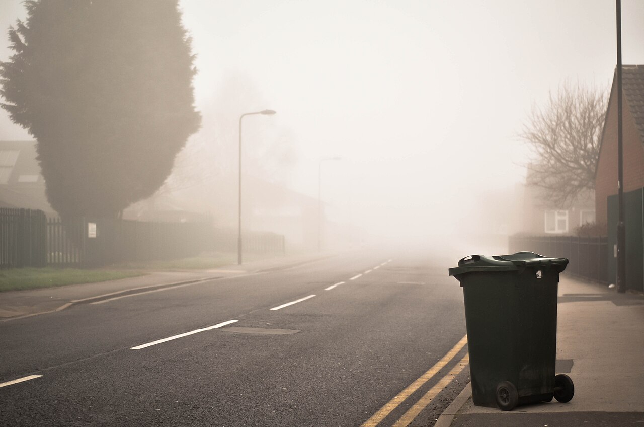 A quiet suburban street on a grey, misty morning