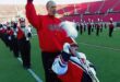Patrick John Hughes pushes his son Patrick Henry Hughes in his wheelchair with the Louisville marching band