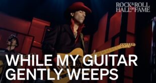 Prince playing a guitar solo during While My Guitar Gently Weeps at the 2004 Rock Hall ceremony