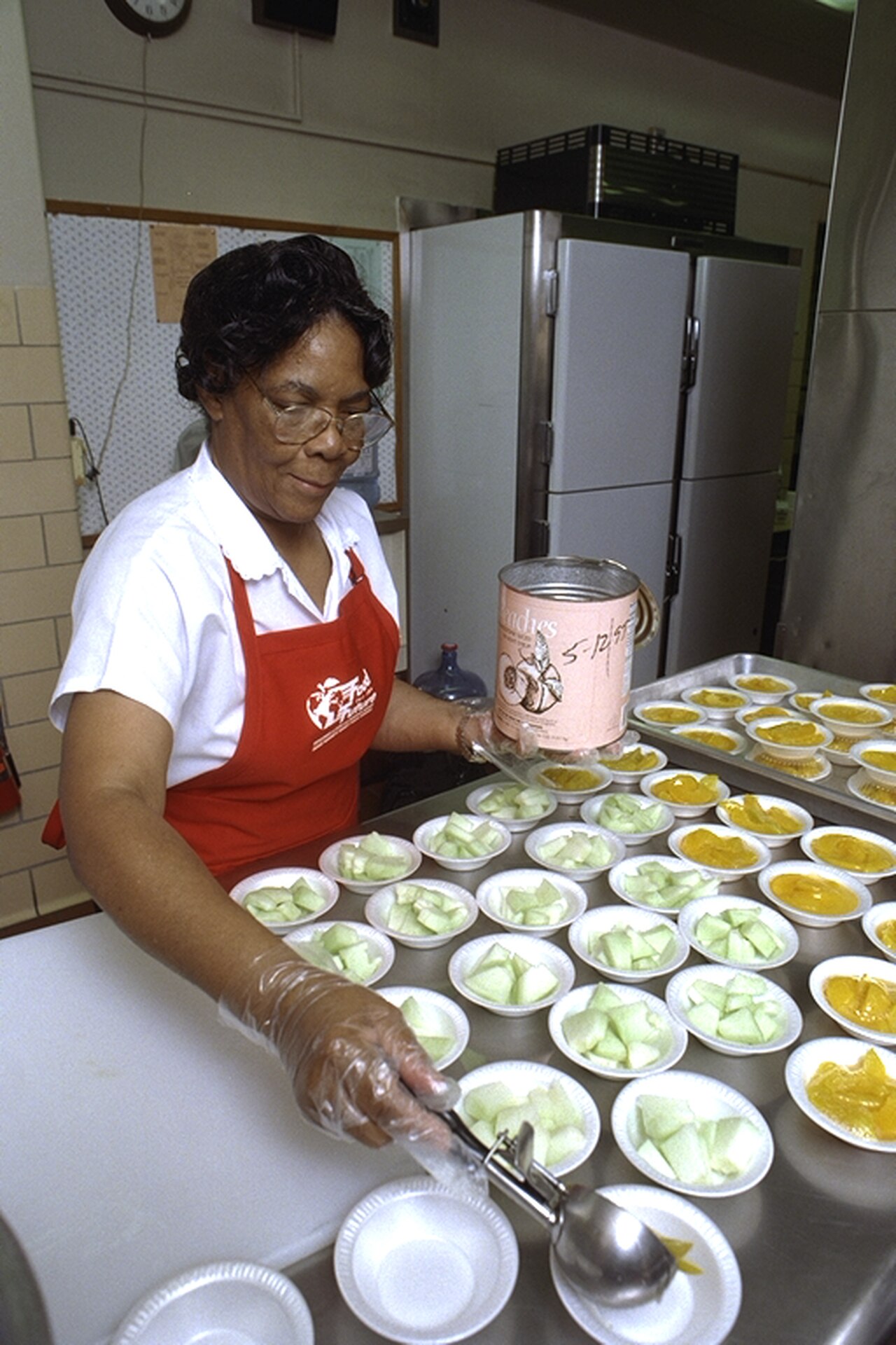 A school cafeteria worker preparing lunches