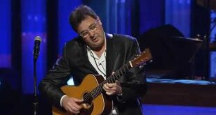 Vince Gill playing guitar as he sings Go Rest High on That Mountain at George Jones' funeral