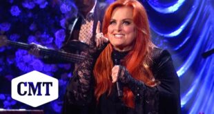 Wynonna Judd singing Love Can Build a Bridge at Naomi Judd's memorial at the Ryman